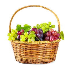 Bunches of green and red juicy grapes with leaves in a basket. Isolated on white.