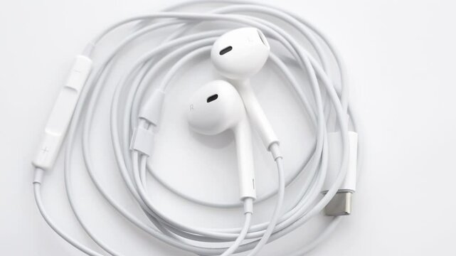 Wired white headphones. Gadgets and electronic devices