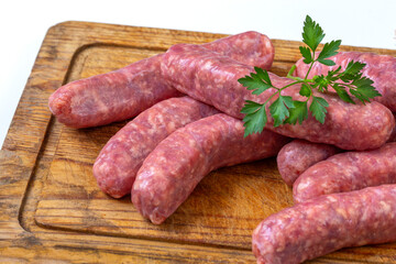 Fresh sausages on a wooden cutting board