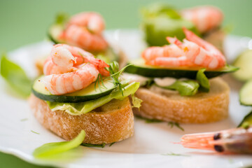 Light festive canapes with seafood, greens and fresh vegetables