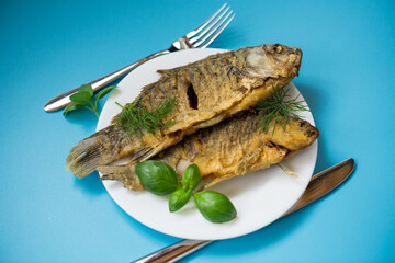 Traditional Ukrainian fried crucian carp in a village kitchen