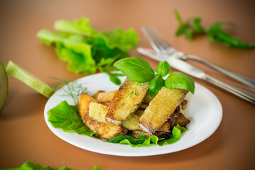 Vegetable appetizer of zucchini and dill on a brown background