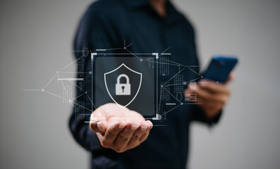 man holding smartphone with holographic lock and data network graphics. Concept of cybersecurity,...