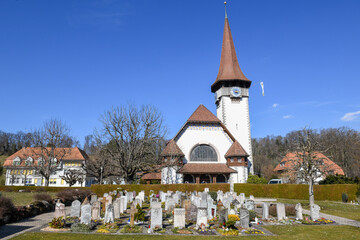 View at cementery and church of Spiez in the Swiss alps