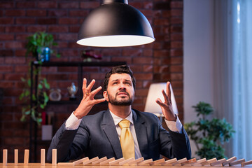 Indian executive triggers domino fall to express business pressure and poor outcome and frustration