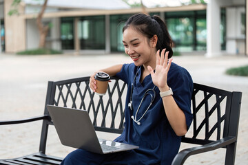 Doctor engaging in telehealth consultation outdoors with laptop and coffee
