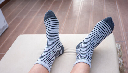 Gray socks with black stripes on boys feet
