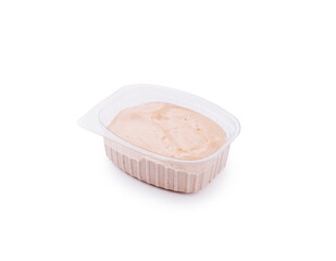 Creamy dipping sauce in a clear container ready for serving snacks