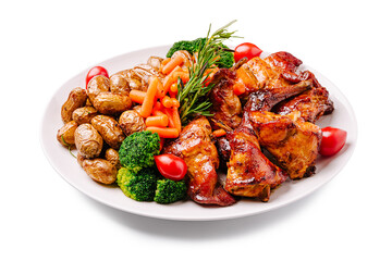 Delicious grilled pork meat with vegetables and potatoes served on a white plate