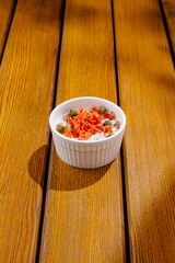 Colorful dish presented on a wooden table captures vibrant culinary art