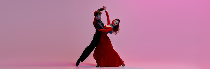An elegant couple dances the Argentine tango on a softly lit pink stage background. Concept of passion and grace in dance. Banner