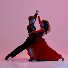 Argentine tango dancers strike a dramatic pose against a vibrant pink and purple gradient backdrop. Concept of passionate dance artistry and cultural expression.