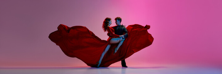 Argentine Tango dancers engage in a passionate performance, with one adorned in a striking red...