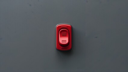 Displaying red rocker switch on gray panel, featuring sliding actuator with textured grip lines