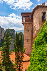 Historic monastery tower with wooden balcony overlooking cliffs in Meteora Greece