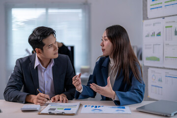 Two people are talking in a business meeting