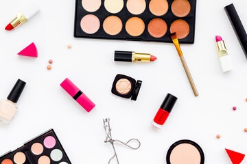 Various makeup cosmetic products - blusher, mascara, lipstick, nail polish and brushes, top view