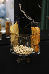 Nuts and potato chips on the buffet table.
