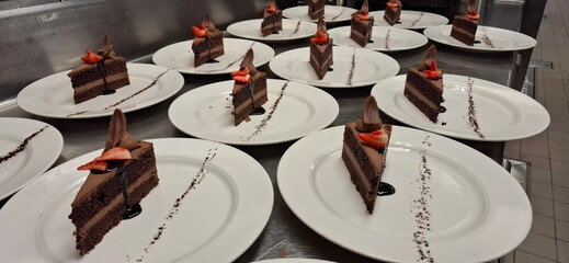 Beautifully Presented Chocolate Cake Slices with Strawberries in a Culinary Setting