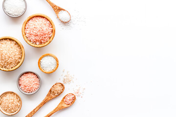Spa composition with many different kinds of sea salt in bowls, top view