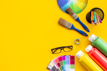 Creative designer workspace with color paint swatches and brushes