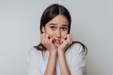 Young woman displaying fear and anxiety with an anxious expression, suitable for discussions on...