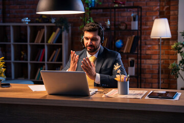 Indian executive with headset busy in call center, symbolizing communication and customer service