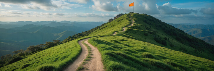 Winding narrow mountain trail path leading to hilltop orange flag on summit, blue sky, achievement, success journey, motivation, perseverance, outdoor adventure, challenge, business, lifestyle image