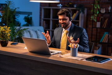 Indian executive with headset busy in call center, symbolizing communication and customer service