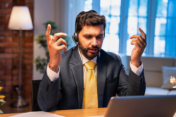 Indian executive with headset busy in call center, symbolizing communication and customer service
