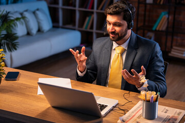 Indian executive with headset busy in call center, symbolizing communication and customer service