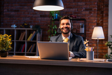 Indian executive with headset busy in call center, symbolizing communication and customer service