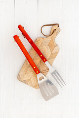 Top view of barbecue utensils with cutting board. Picnic party concept
