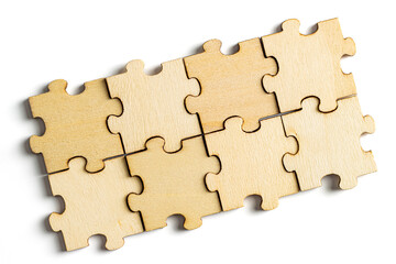 Fototapeta premium Wooden jigsaw puzzle pieces isolated on white background.