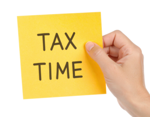 A hand holds a yellow sticky note with the message "TAX TIME" written in bold black letters against a black background.