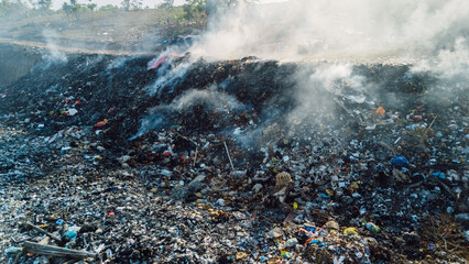 Burning dumb emitting smoke, highlighting environmental pollution and waste management challenges