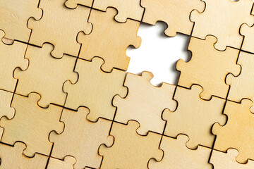 incomplete wooden jigsaw puzzle, with one final piece of jigsaw puzzle to complete the puzzle.on...