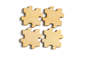 wooden jigsaw puzzle pieces isolated on white background.