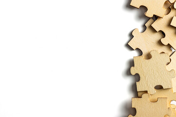 blank empty white space with scattered wooden jigsaw puzzle as frame. empty space for copy spaces.