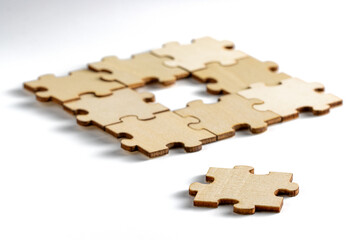 incomplete puzzle pieces, with seperated final pieces. Work and business concept with white background.