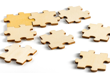 Incomplete wooden jigsaw puzzle on white background. 