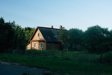 Old house in the village at sunset