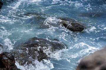 Waves hitting volcanic shoreline