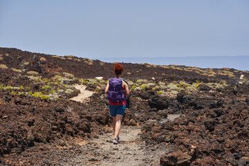 Hiker on volcanic trail Tenerife
