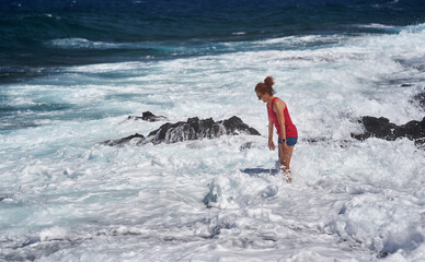 Happy woman enjoying the waves