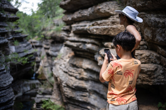 Tourists taking pictures of rock formations in natural park