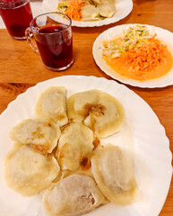 pierogi (fried dumplings), cabbage salad and compote served in a small restaurant
