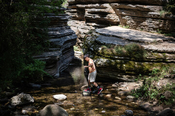 Young hiker exploring stunning canyon with hiking pole