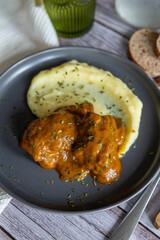 homemade recipe of pork cheeks with gravy and mashed potatoes