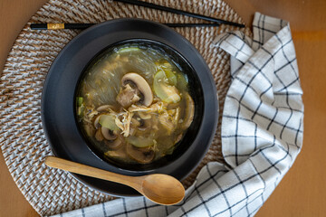 homemade ramen recipe with egg, vegetables and noodles in black bowl